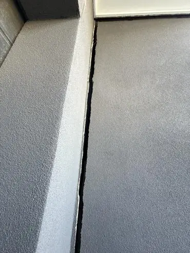 Full-height crack between the garage wall and the house